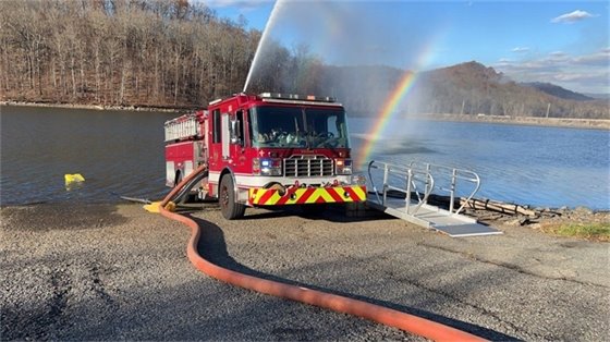 fire truck next to reservoir