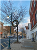 a lamppost decorated with a holiday wreath on summit downtown street