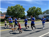 image of group of people running down a street