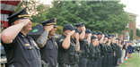image of line of Summit Police Officers saluting at National Night Out