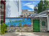 image of colorful mural on a low stone wall in downtown Summit