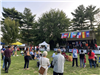 image of group of people gathered in front of the main stage on the Village Green