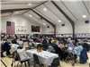 image of people sitting at tables in the main gym at the Summit Community Center for Thanksgiving