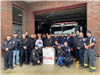 image of police officers and firefighters posing for a photo outside the firehouse