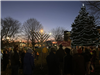 image of people gathered for menorah lighting on the Village Green at night