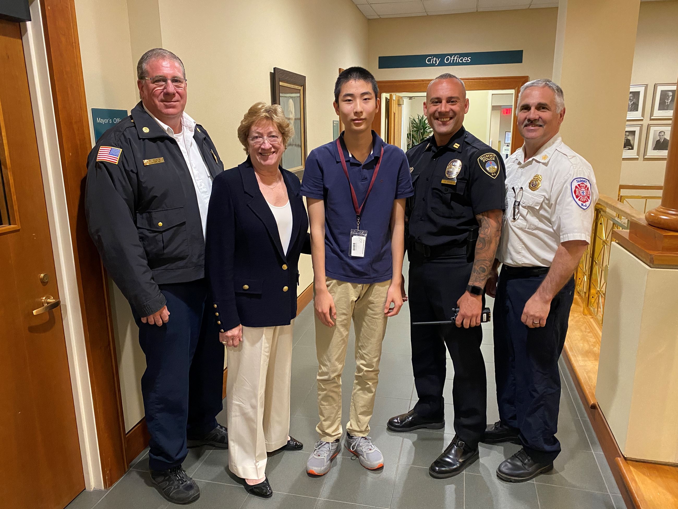 group photo with members of summit police and fire department and mayor for the day summit student