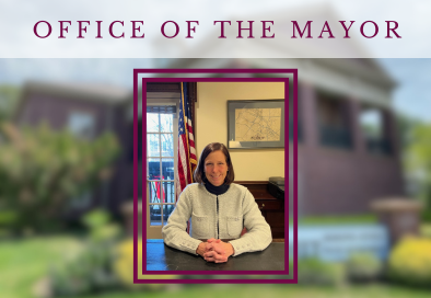 City of Summit mayor sitting at desk and smiling at the camera