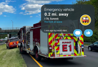 summit firetruck on highway with mobile phone notification of emergency vehicle ahead