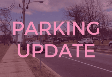 maroon tinted graphic with image of cars parked on a street in the background and text in the foregr