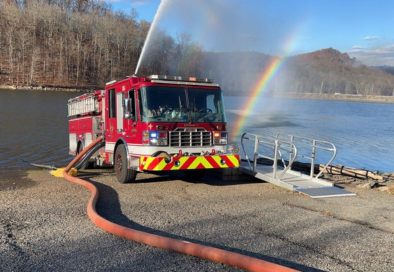 fire engine parked next to reservoir