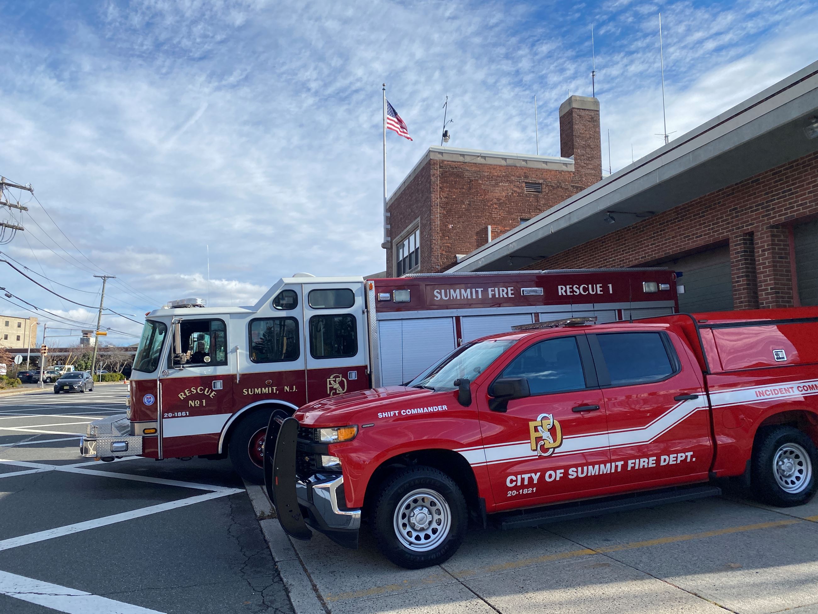Fire vehicles outside brick firehouse