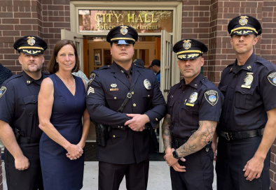 group photo of police officers and mayor