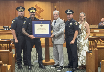group photo of police officers in council chamber