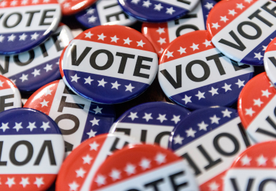 pile of red white and blue vote buttons