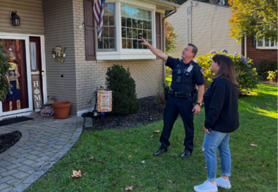 police officer and resident outside home