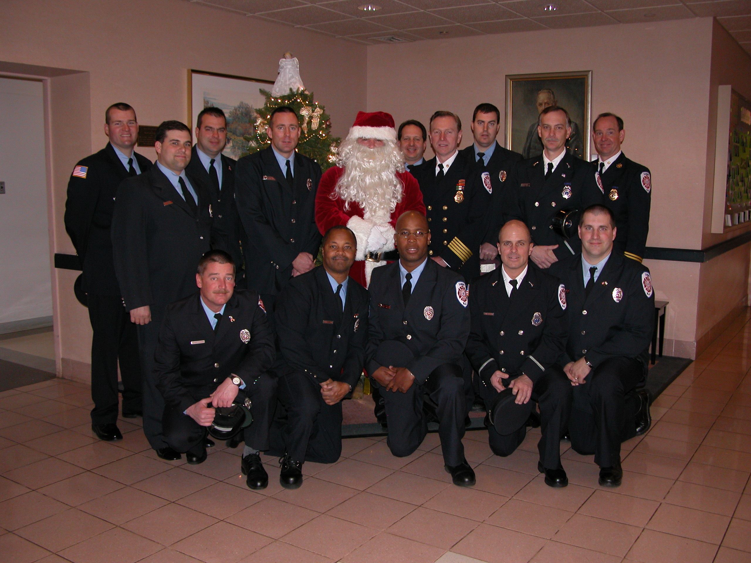 Firefighters surrounding Santa