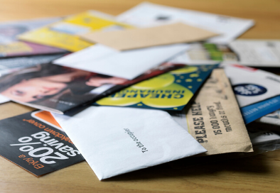 Photo depicting junk mail laid on a table