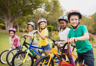image of a group of kids on bikes facing the camera and smiling