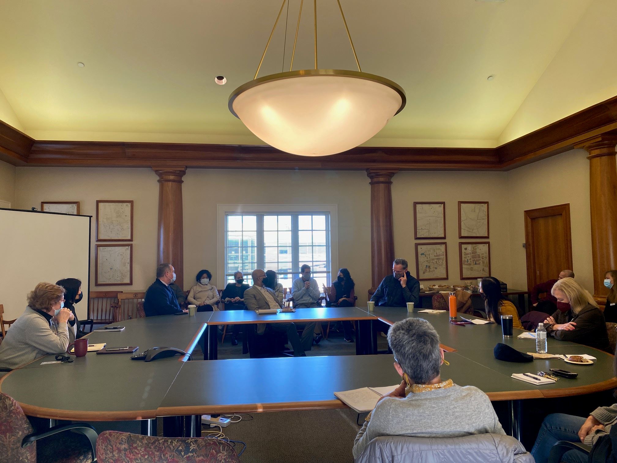 Photo of people sitting around at a circular conference table