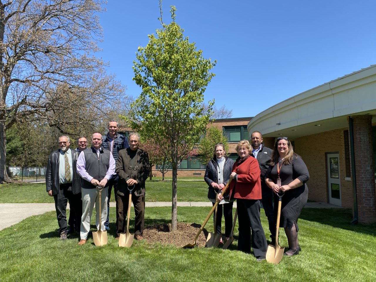 image of group of people posing for a photo near a tree