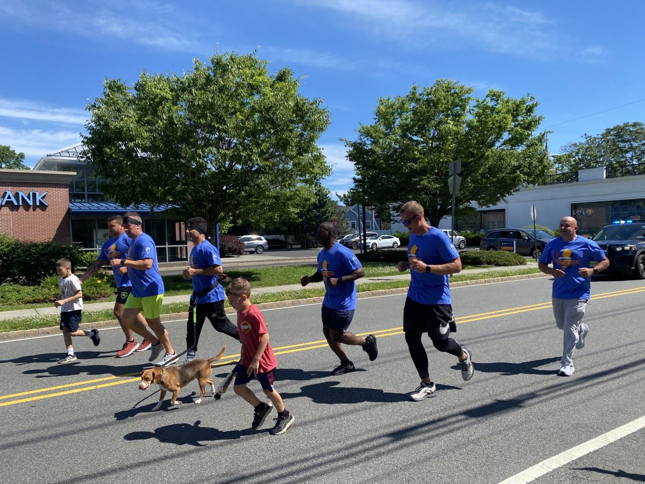 image of group of people running down a street