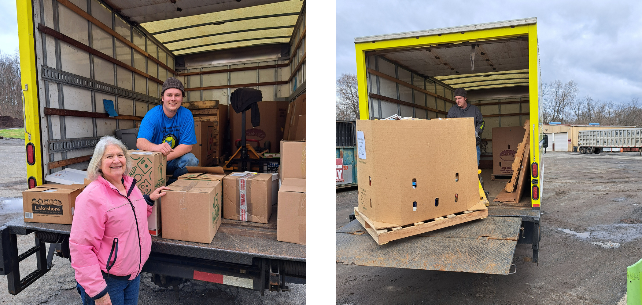 two people smiling for a photo standing at the back of a large truck surrounded by cardboard boxes